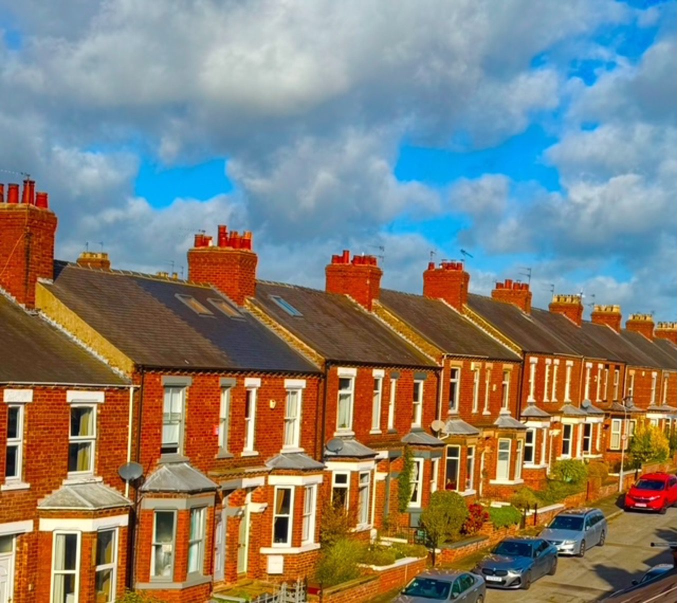 Red cottage home with landscaping